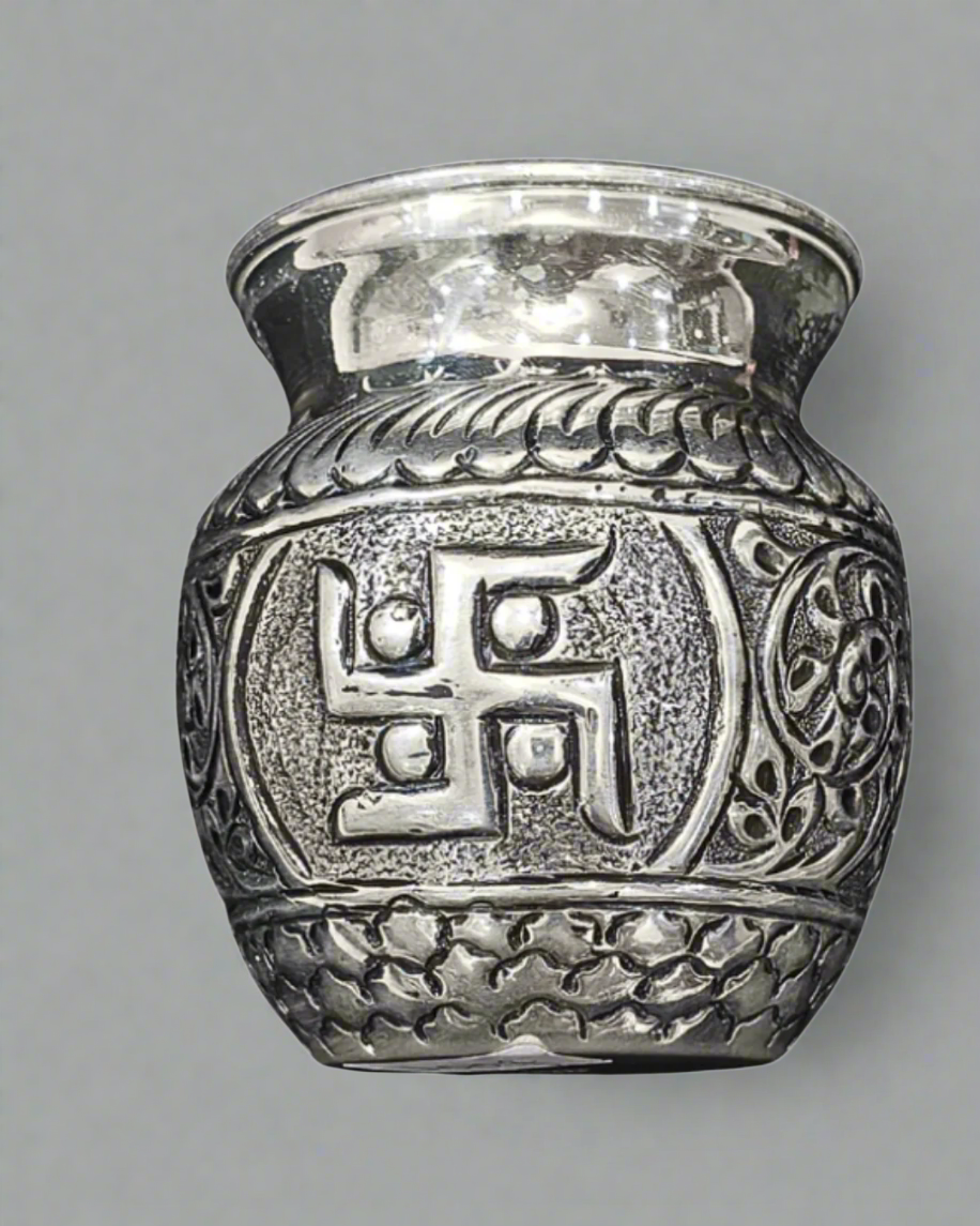Silver urn with swastika design and measurement label on a white background