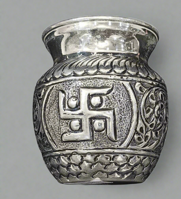 Silver urn with swastika design and measurement label on a white background